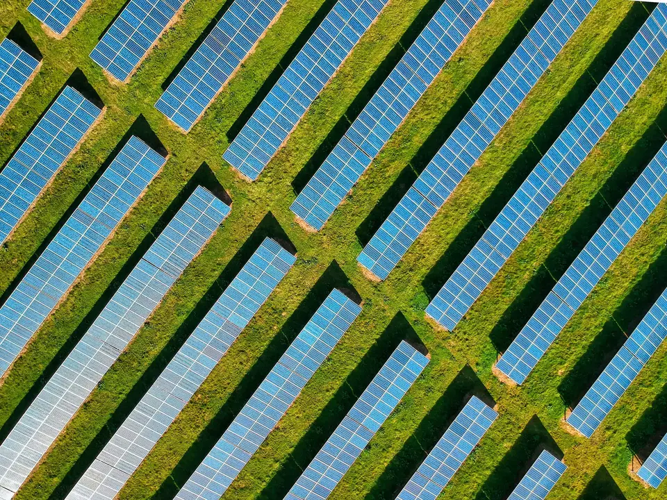 Aerial view of a ground-mounted solar farm in a grid layout